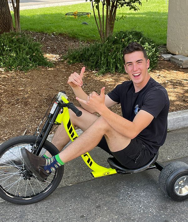 young adult on large trike