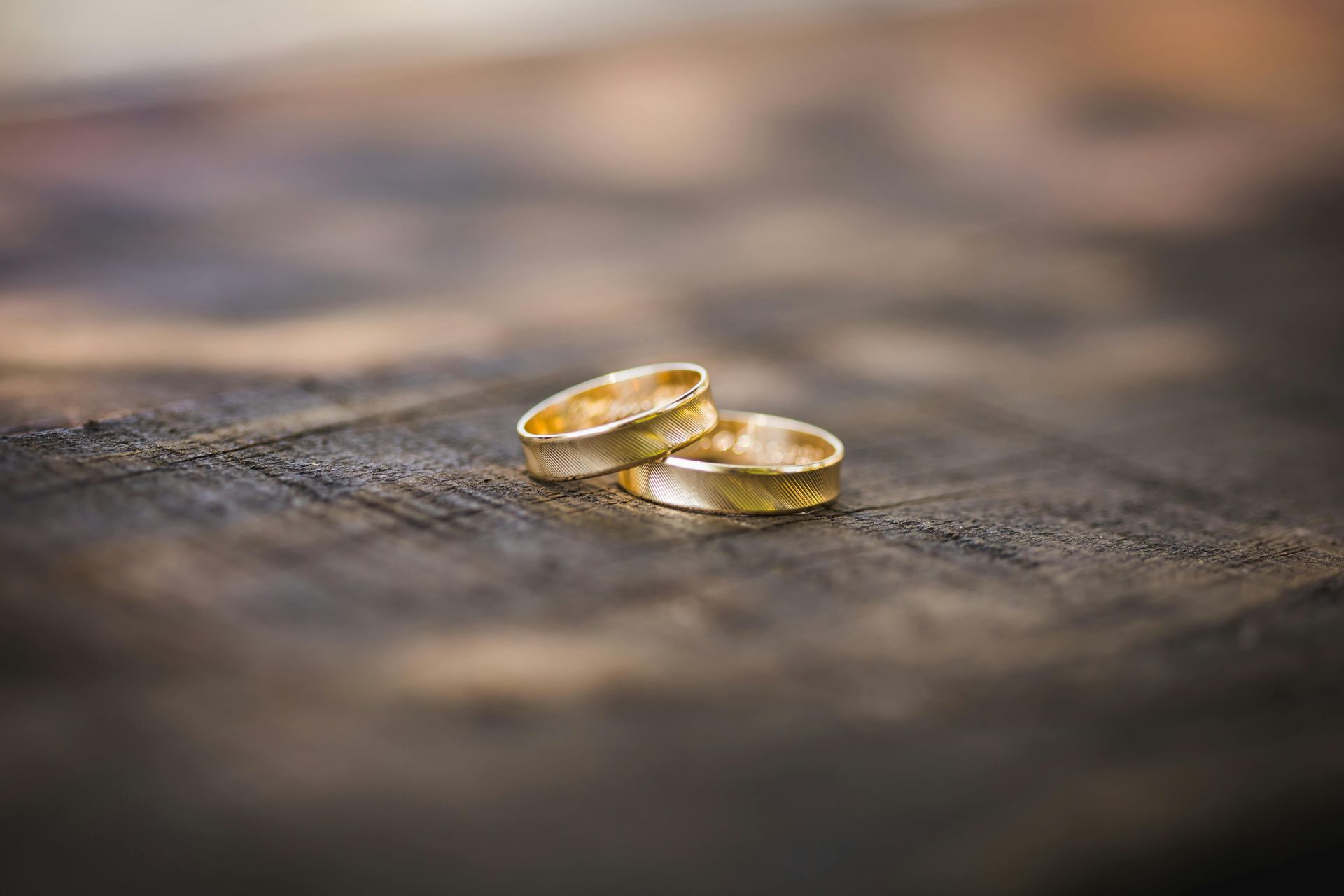 two wedding rings on a wood
board