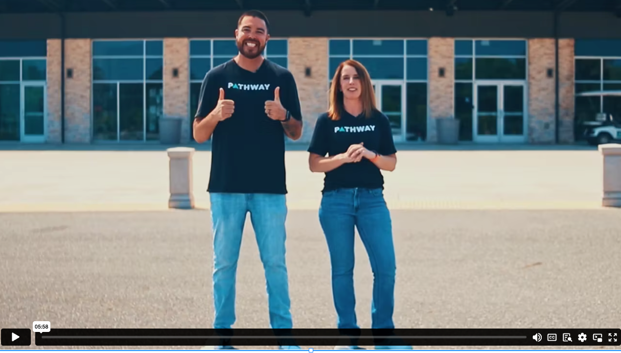 adult man and woman standing in front of a building