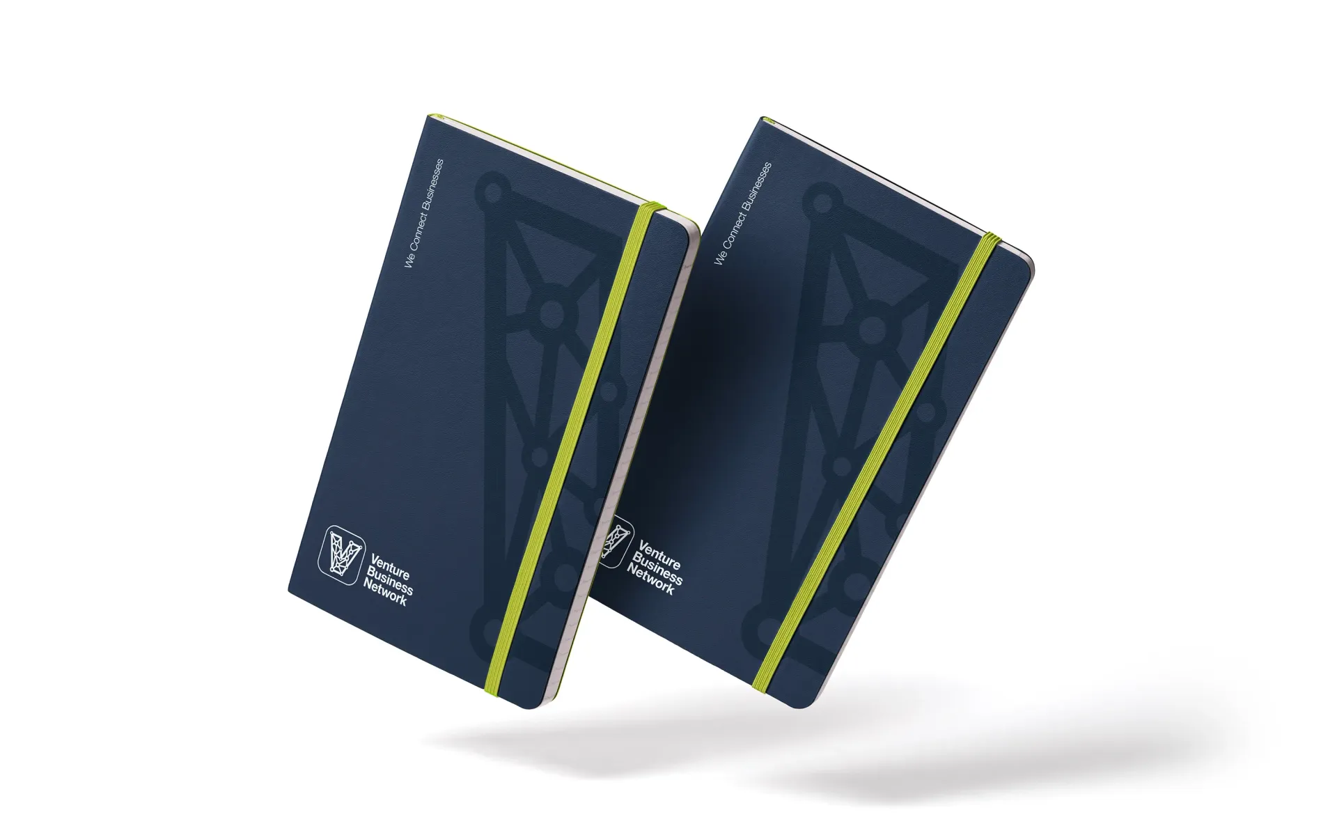 Two navy blue notebooks with yellow elastic bands and logo, slightly angled.