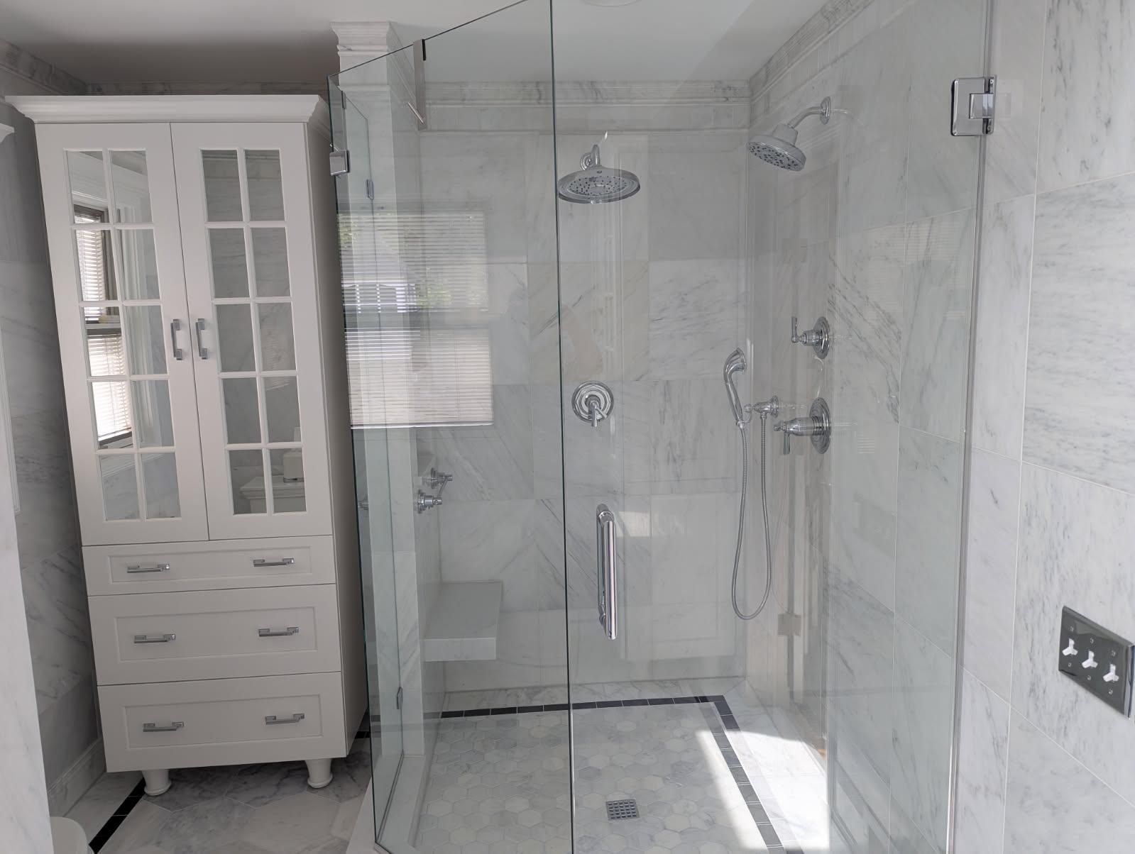 A man is putting ceramic tiles on the walls of a bathroom.