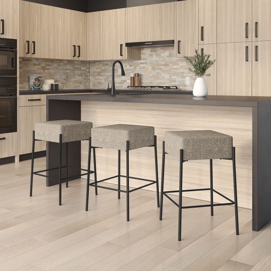 Two wooden bar stools in a minimalist kitchen with a light wood floor and counter
