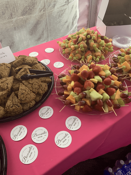 A table with plates of fruit and cookies on it