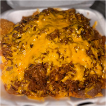 A takeout container of chili or taco meat topped with melted shredded cheddar cheese