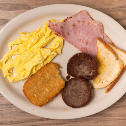 Breakfast plate with scrambled eggs, ham, toast, hash brown, and sausage patties