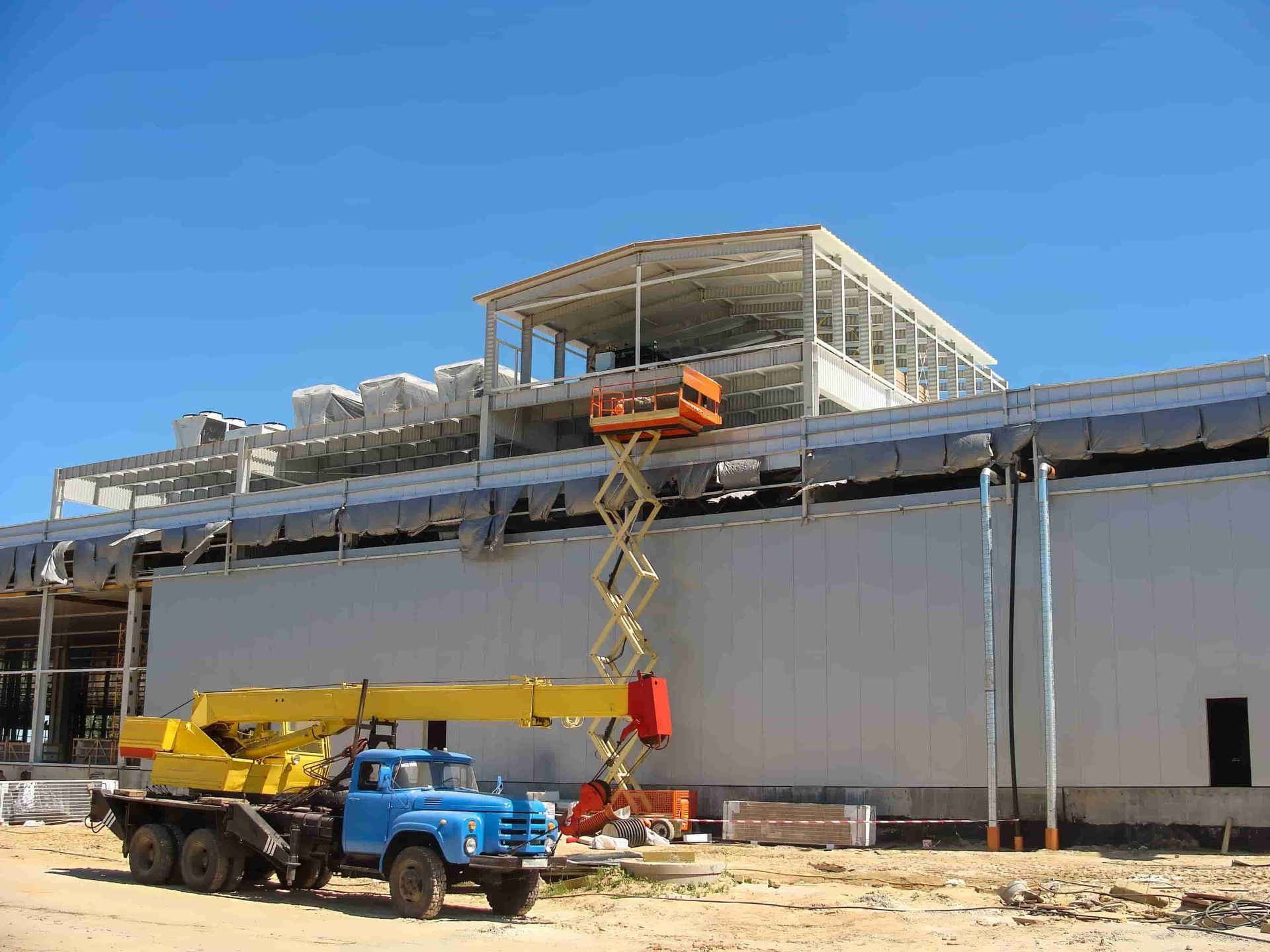 A Blue Truck Is Parked In Front Of A Building Under Construction — B2B Hire In Garbutt, QLD