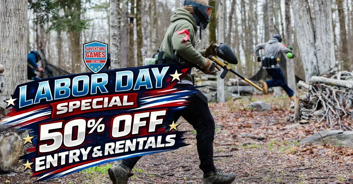 Person in blue playing paintball during Labor Day, outdoor course setting.
