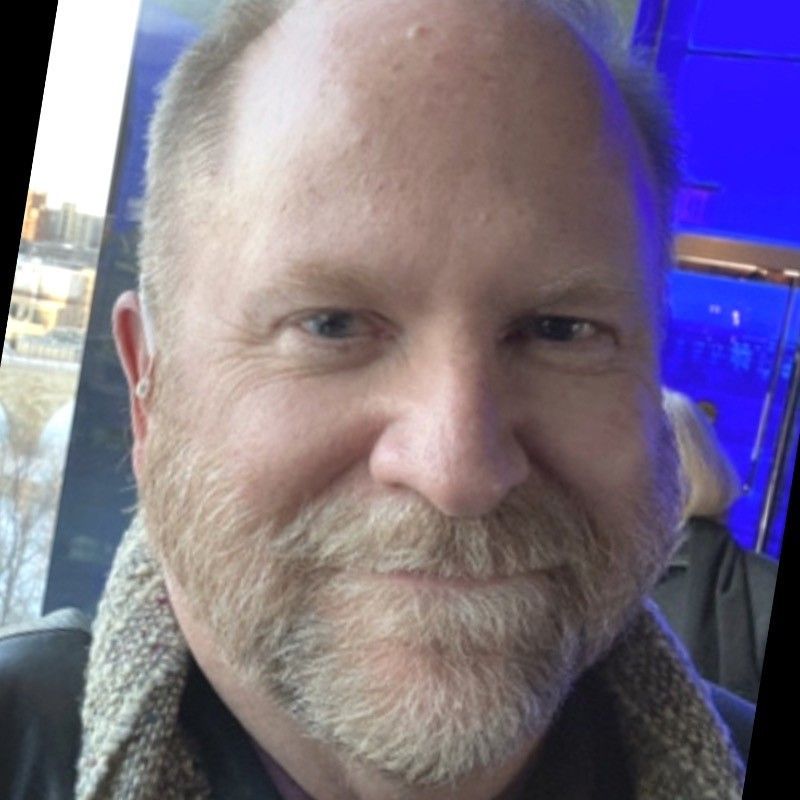 a man with a beard and scarf around his neck | BXB3 Corporation | Archive Solutions in CA