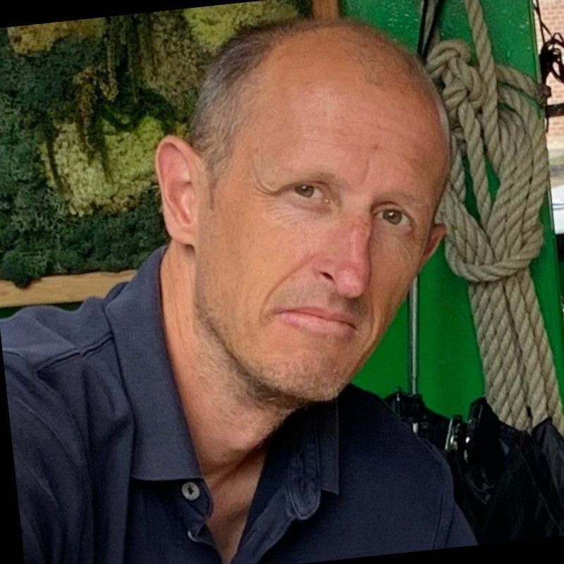 a bald man in a blue shirt is looking at the camera | BXB3 Corporation | Archive Solutions in CA