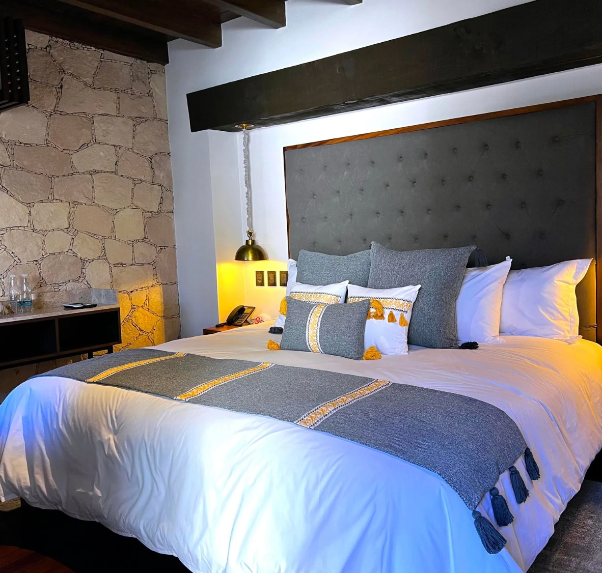 A hotel room with a king size bed and pillows