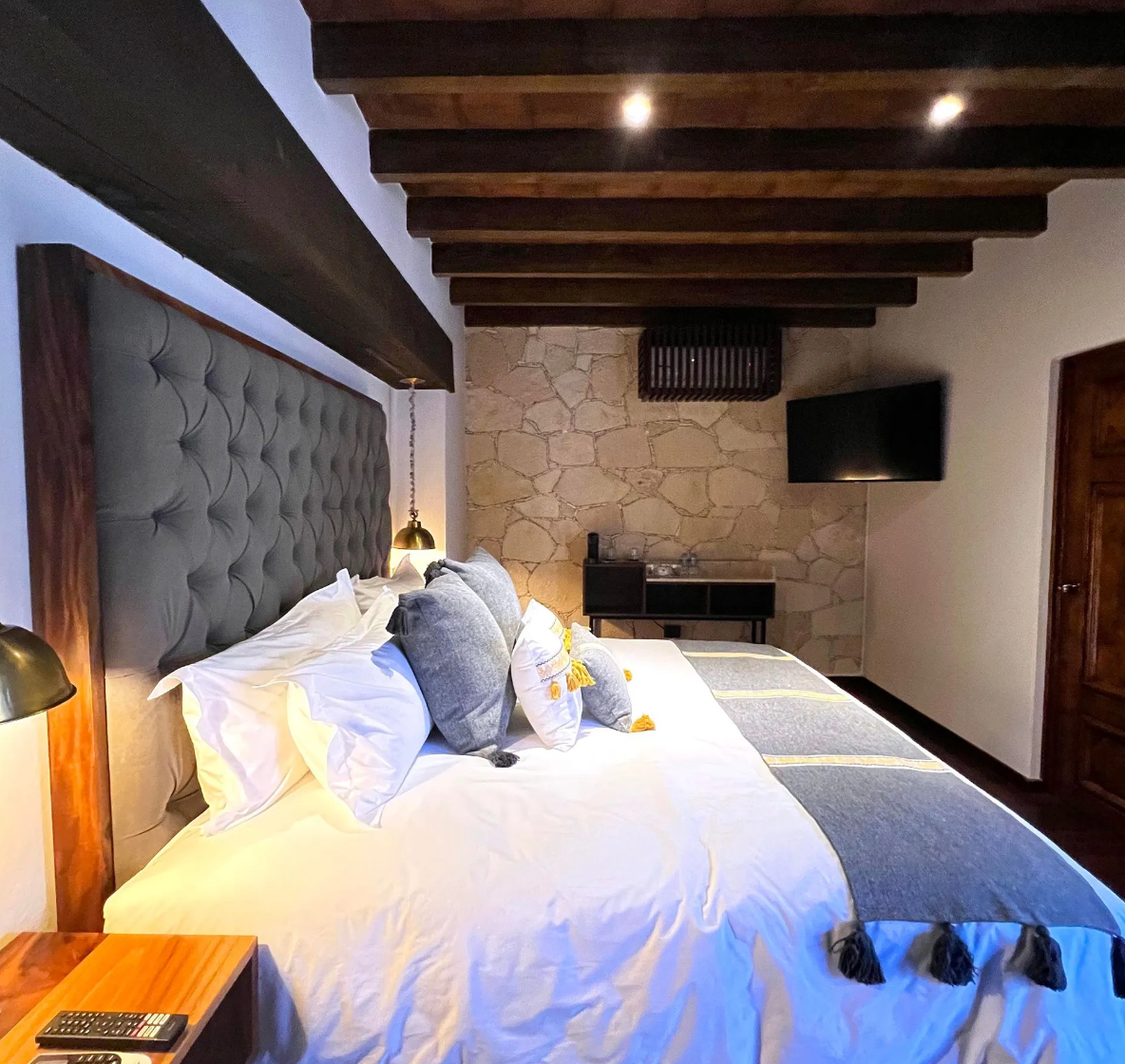 A hotel room with a large bed and a television