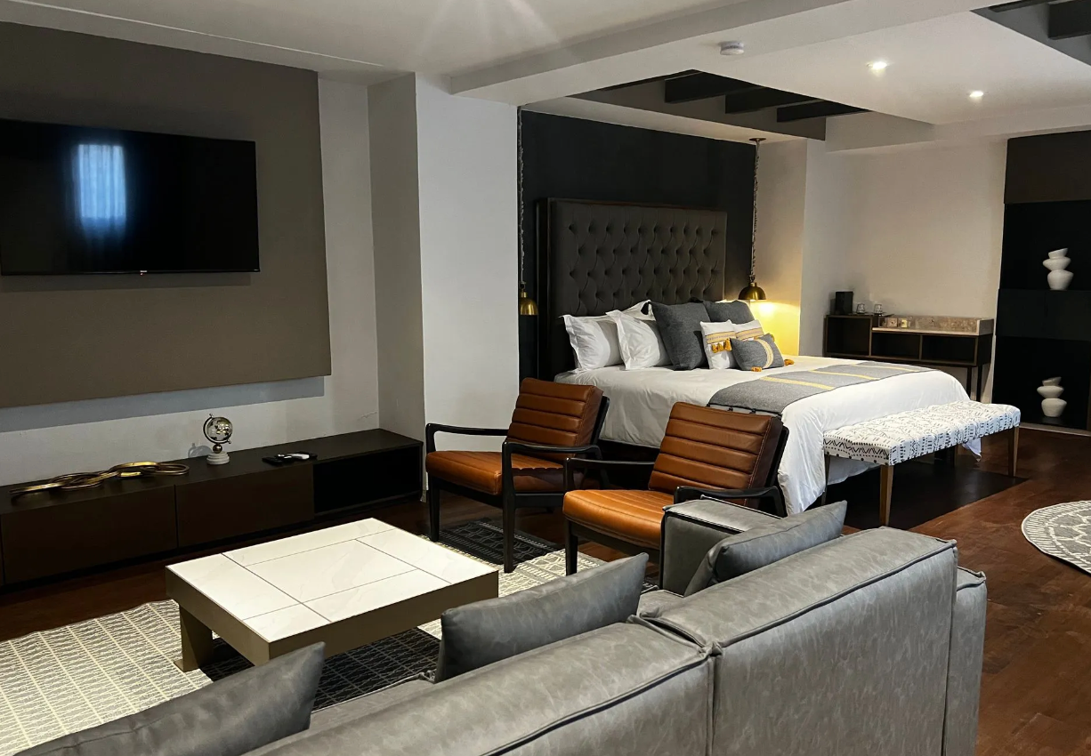 A hotel room with a large bed and a couch