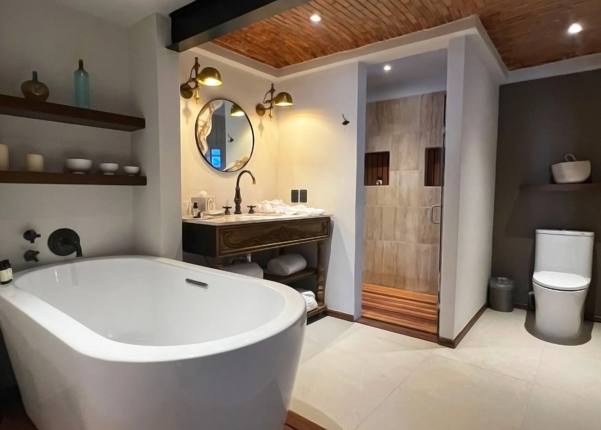 A bathroom with a bathtub , toilet , sink and mirror.