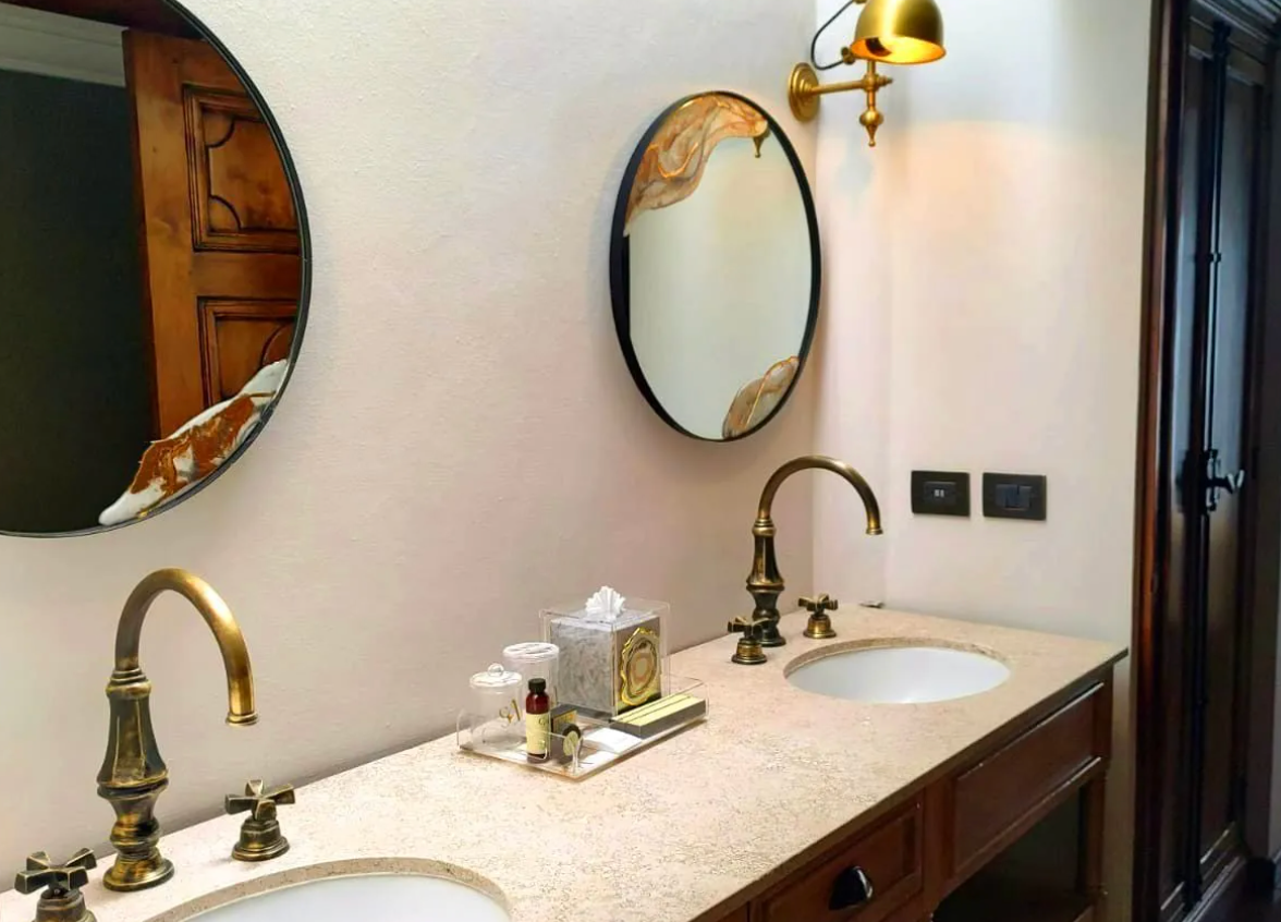 A bathroom with two sinks and two mirrors.
