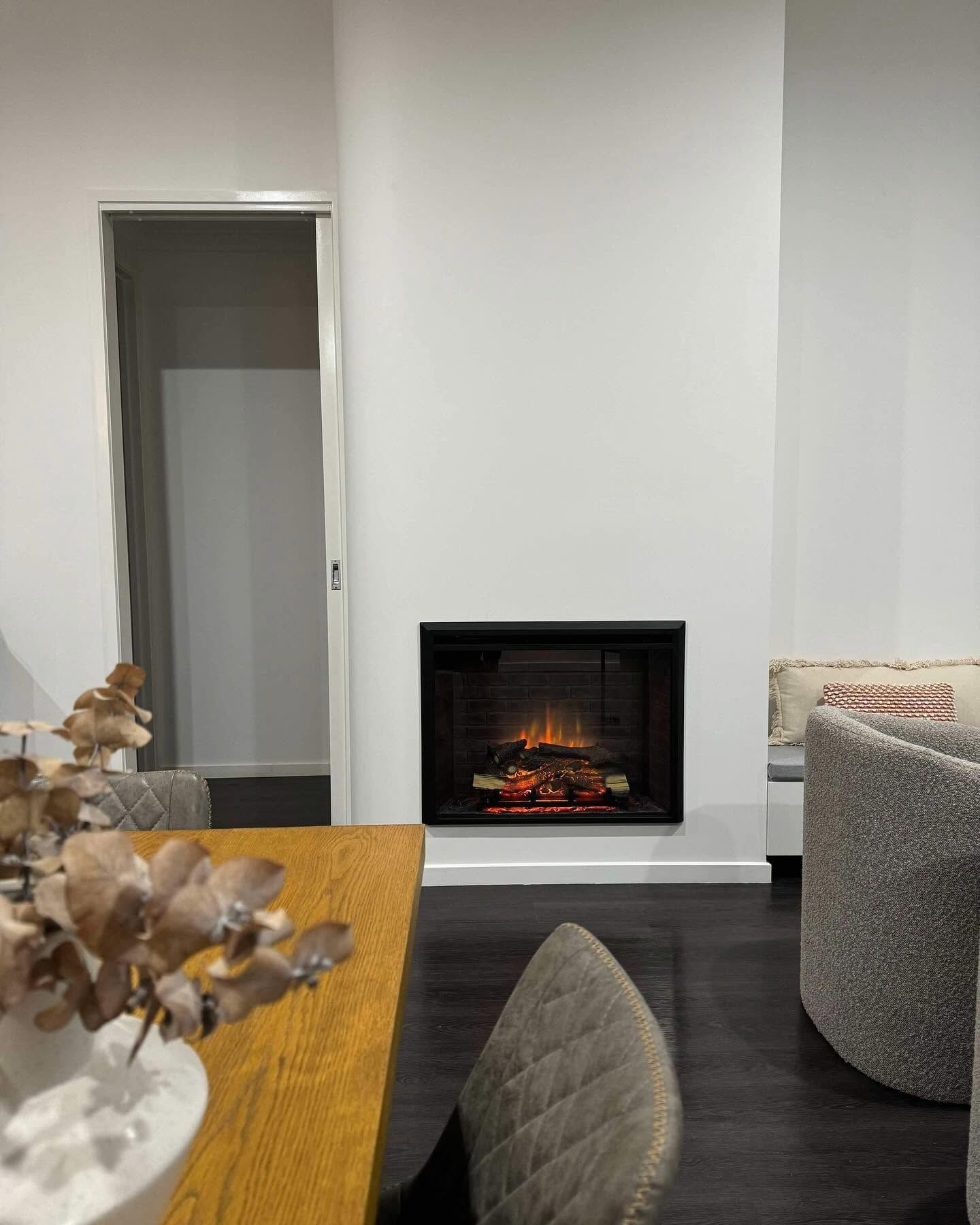 A Living Room with A Fireplace and A Television on The Wall — Flintoff Constructions in Charlemont, VIC
