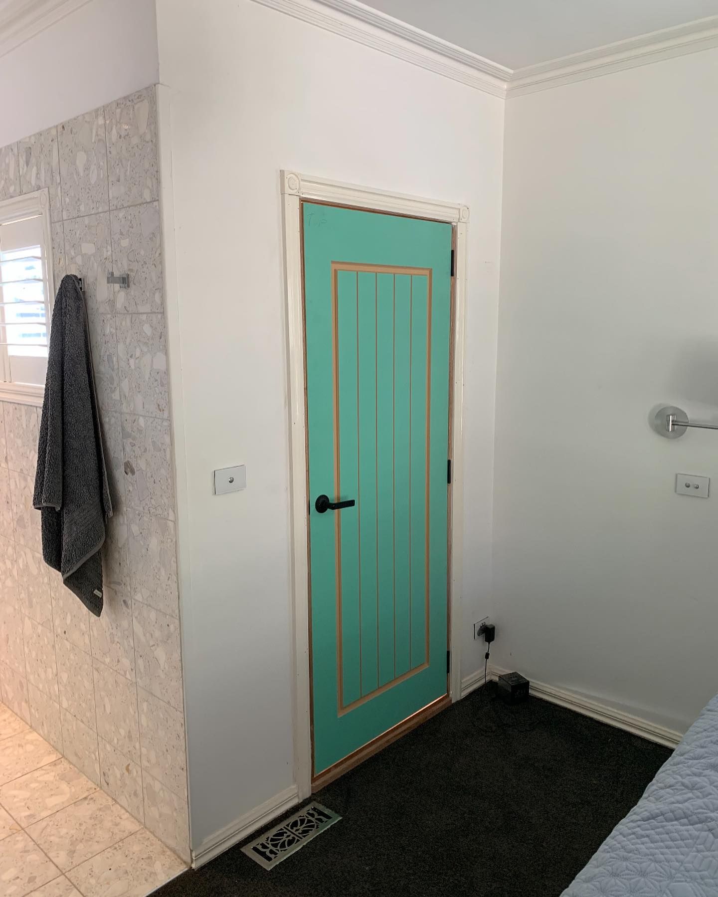 A Bedroom with A Green Door and A Black Carpet — Flintoff Constructions in Charlemont, VIC