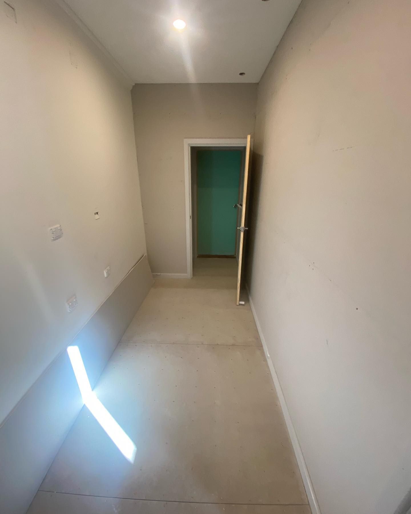 A Long Hallway with A Door in The Middle of It — Flintoff Constructions in Charlemont, VIC