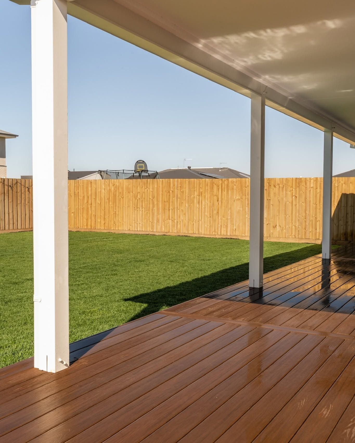 Patio with A Sliding Glass Door and A Brick Building in The Background — Flintoff Constructions in Charlemont, VIC