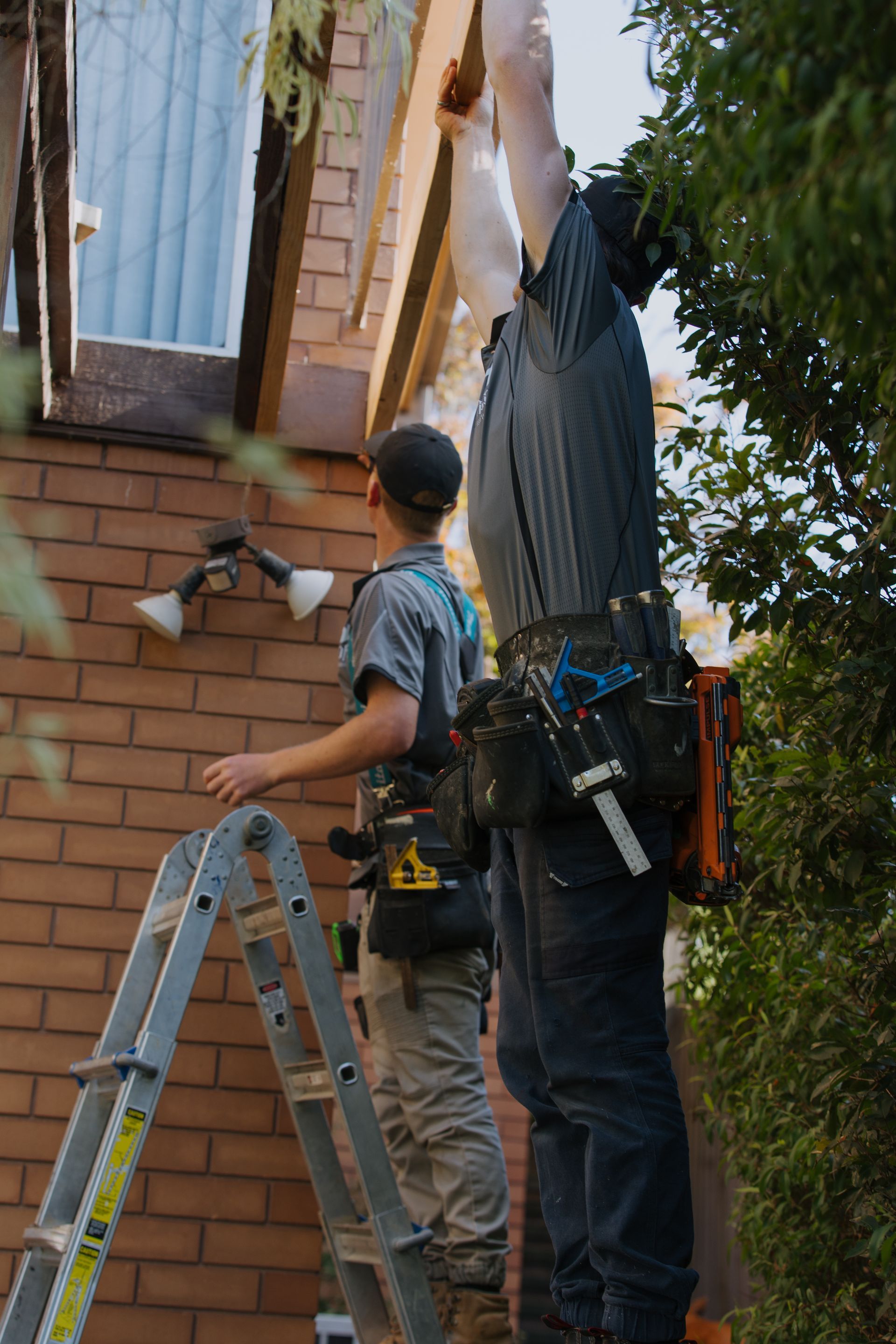 Two men are working on building an outdoor deck — Flintoff Constructions in Charlemont, VIC