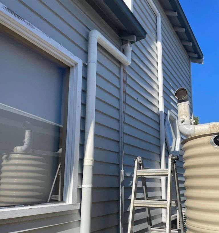 A Brown Gutter Is Attached to The Roof of A House — Flintoff Constructions in Charlemont, VIC