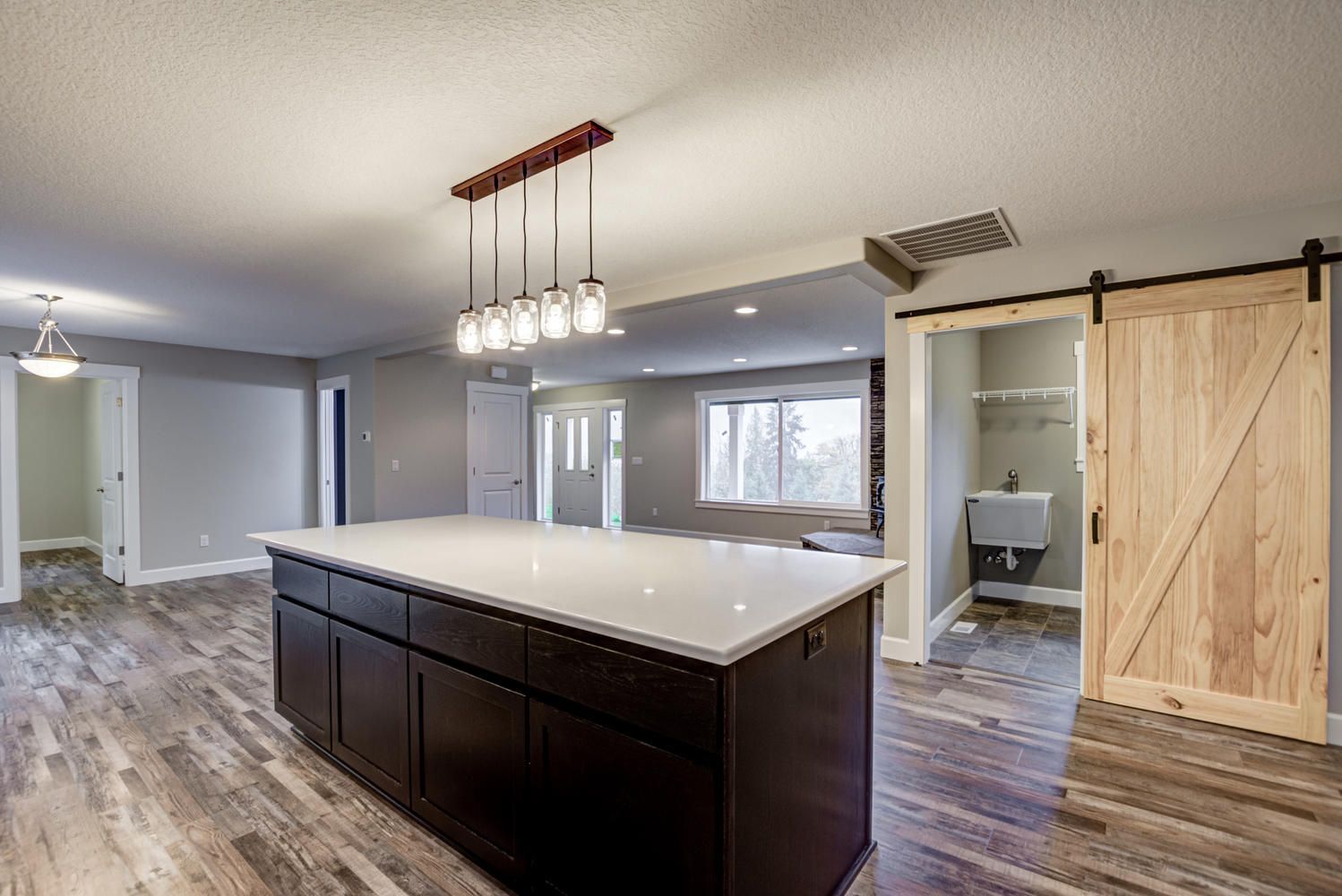 A kitchen with a large island and sliding barn doors.