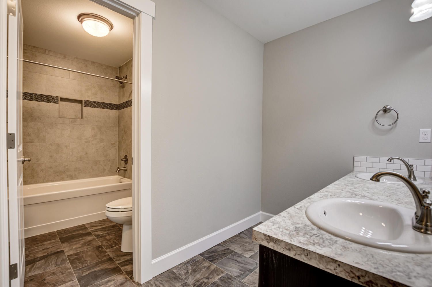 A bathroom with a sink , toilet and bathtub.