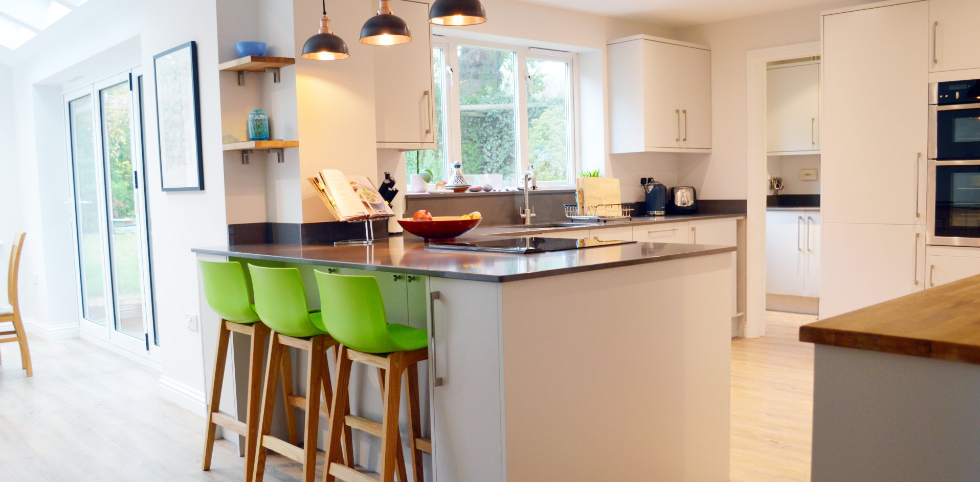 modern kitchen with lime green high chairs