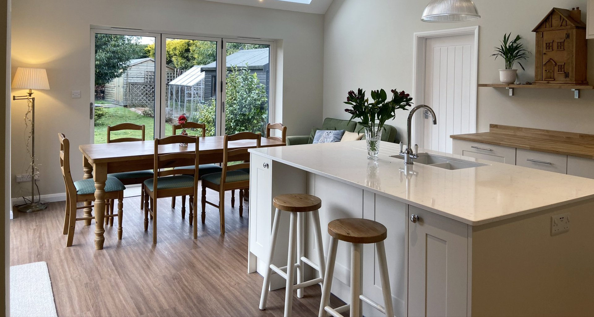 modern kitchen with bar stools and dining area