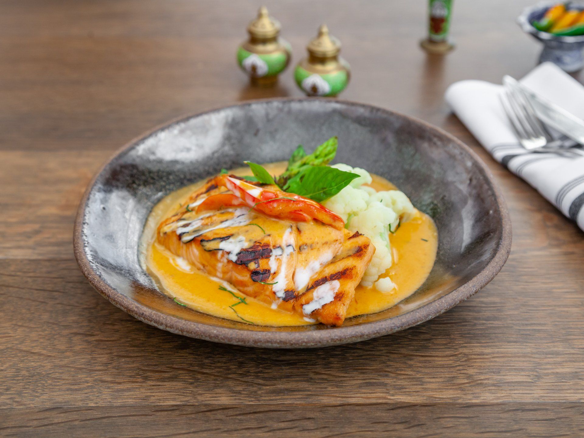 Grilled salmon served with our delicious Thai red curry sauce.