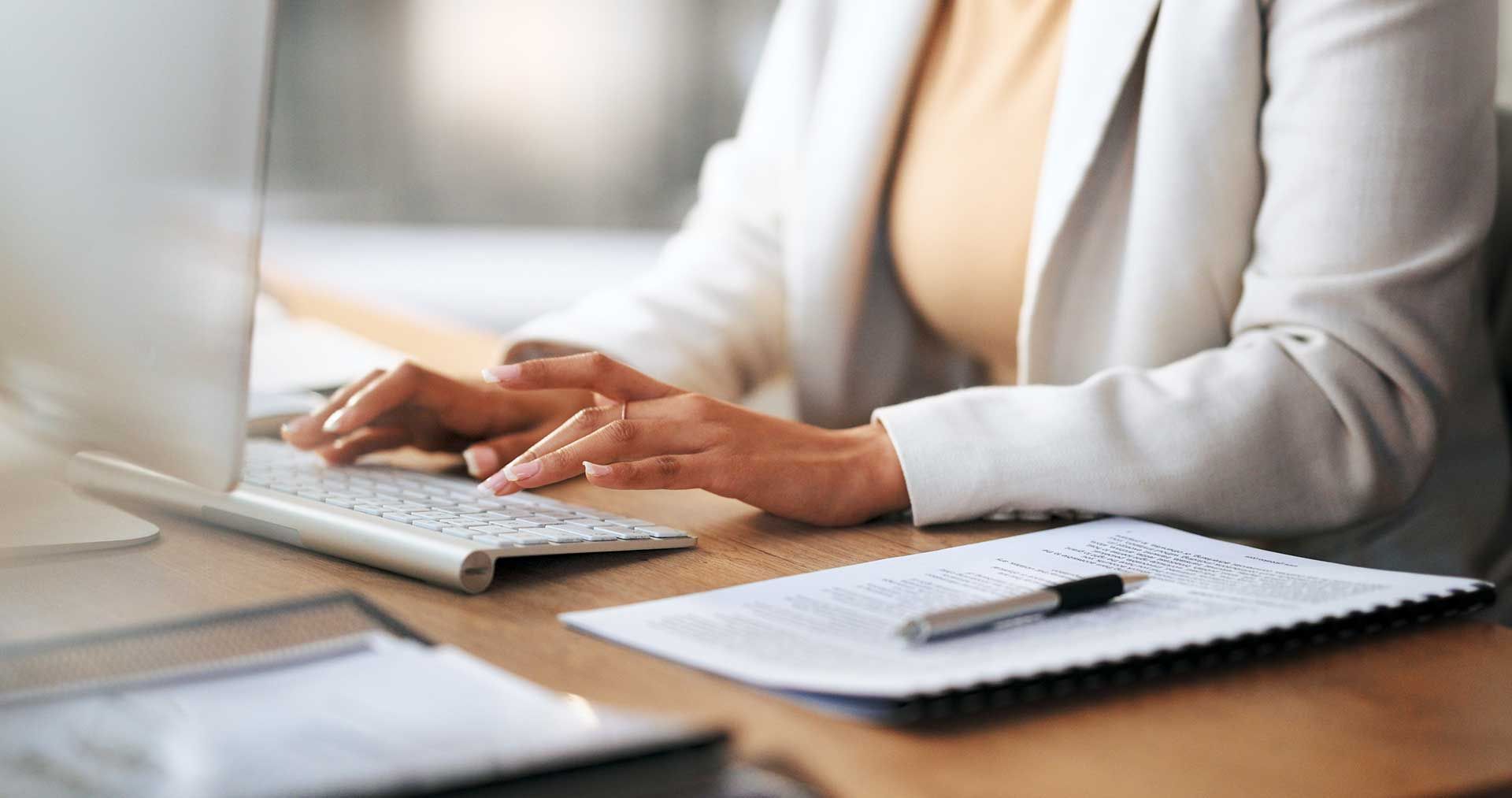hands of a receptionist typing and sending