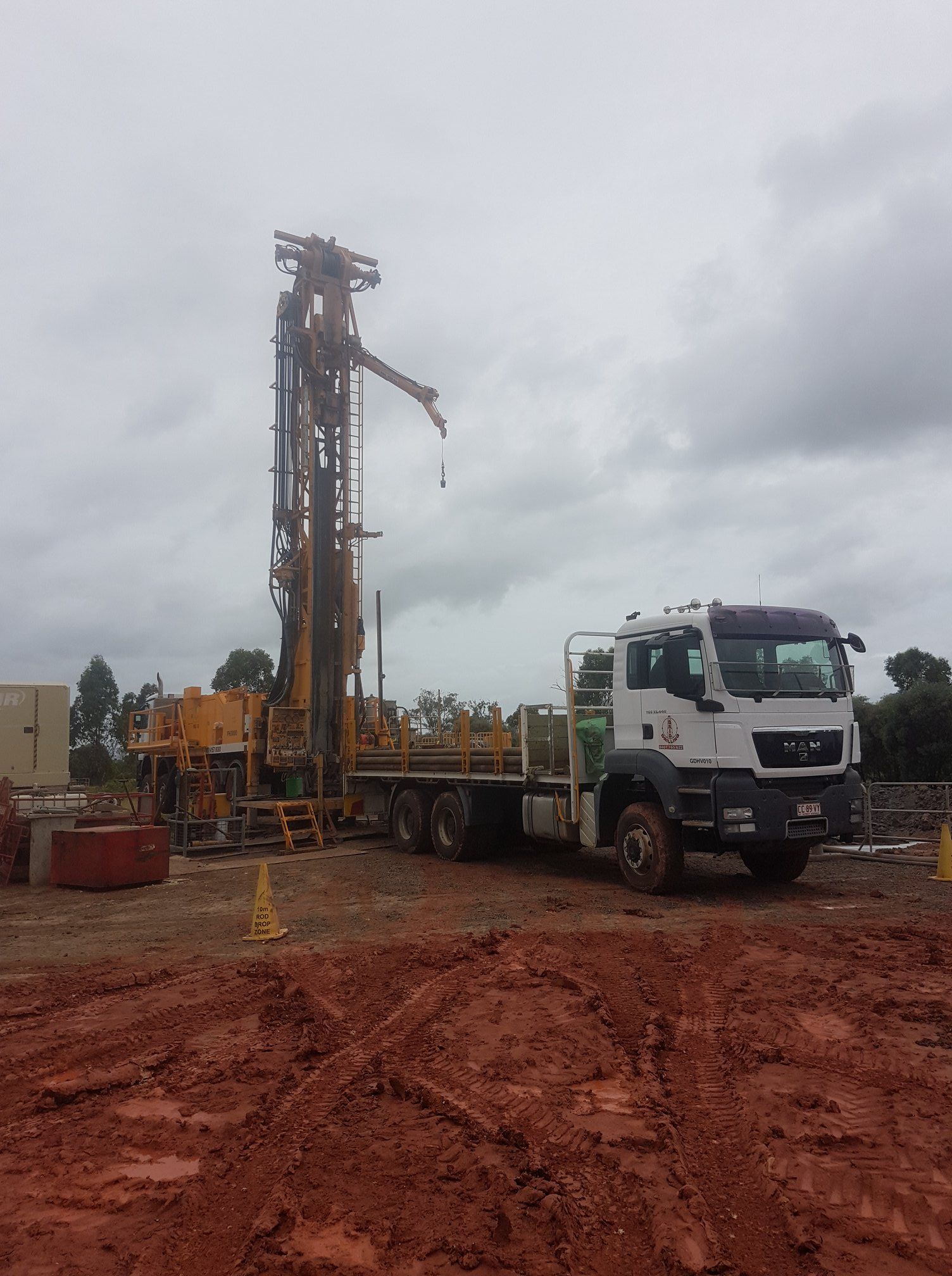 Drilling Rig Truck Stationed on Muddy Location — Grid Drilling in Bucca, QLD