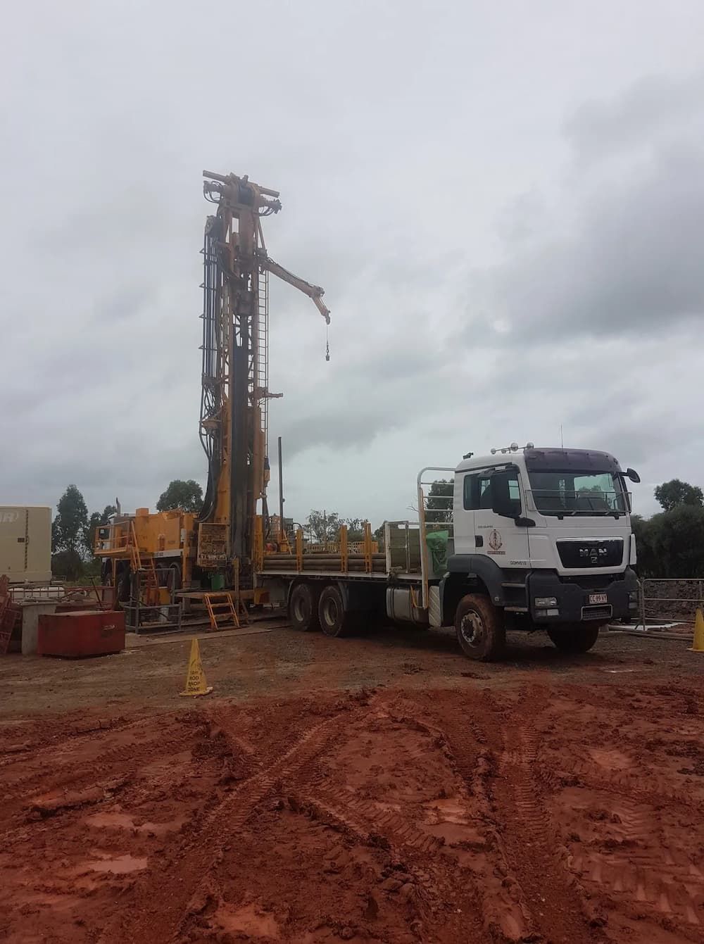 Drill Rig Stationed in a Muddy Cattle Farm — Grid Drilling in Childers, QLD