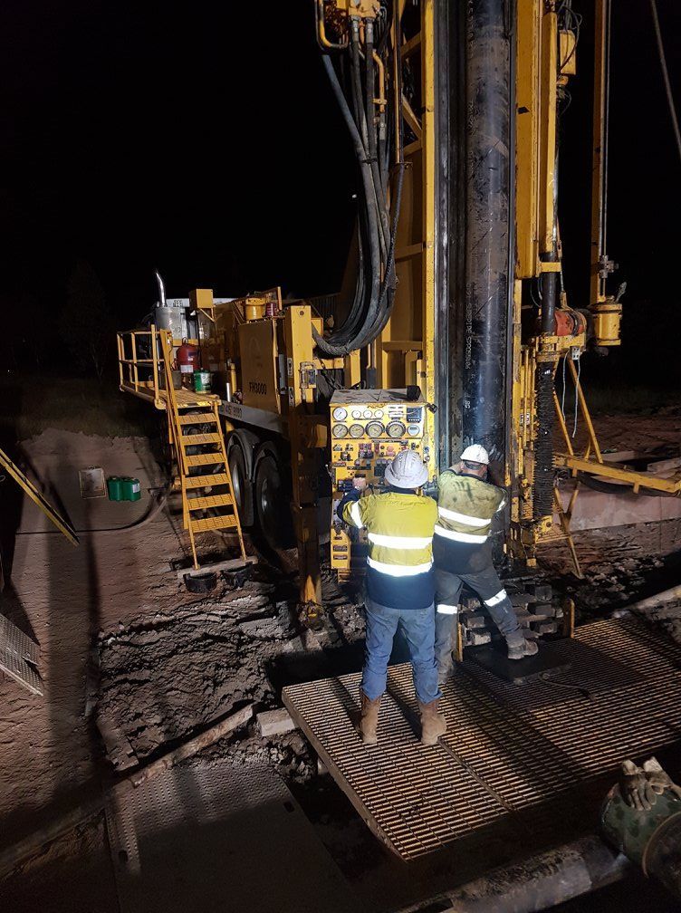 Two men operating drilling rig — Grid Drilling in Maryborough, QLD