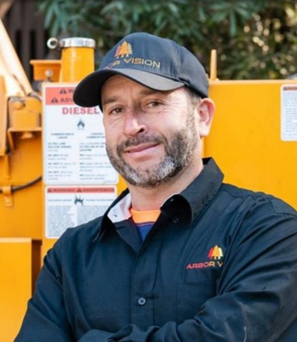 Gustavo of Arbor Vision in front of a tree equipment