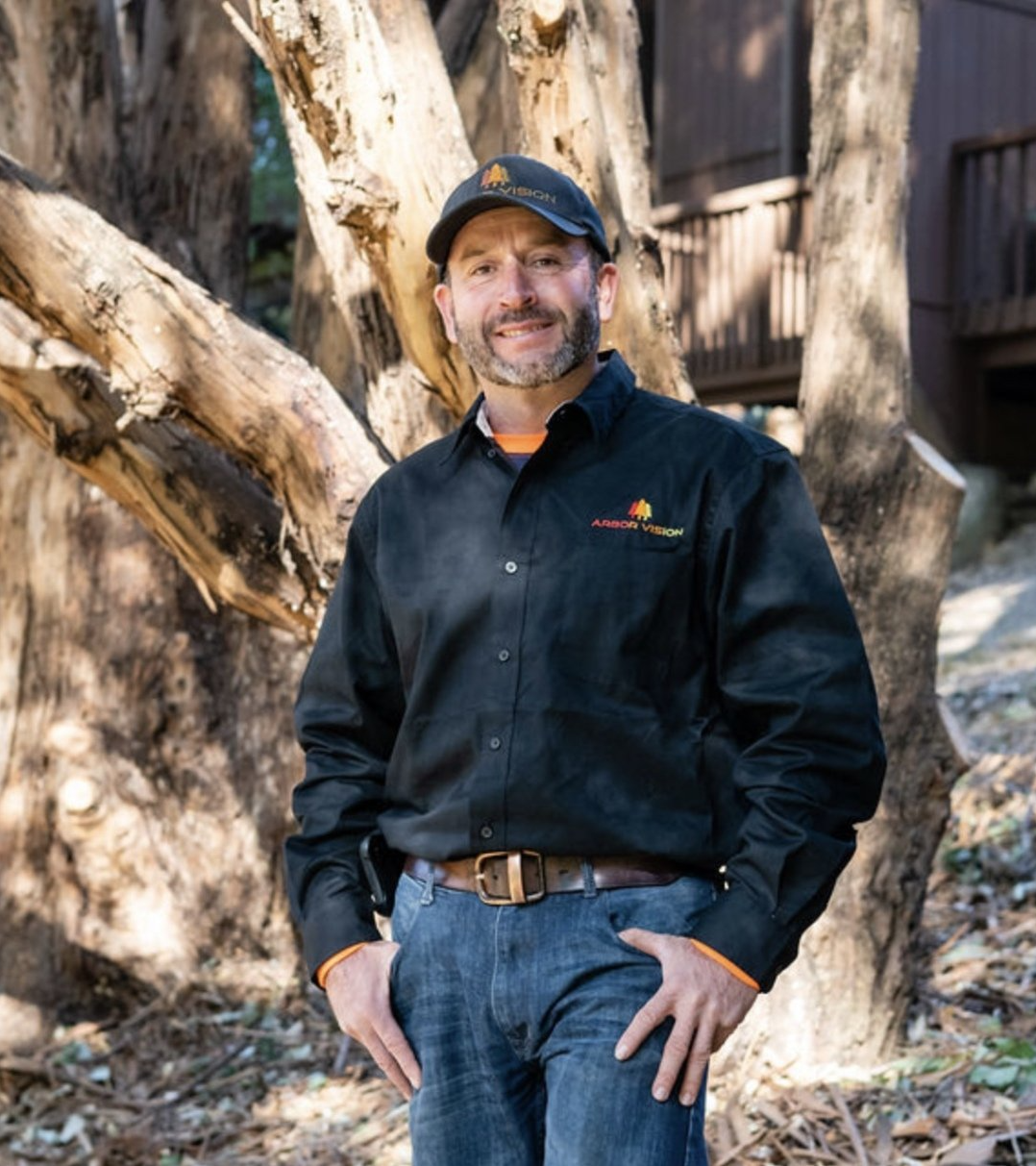 Arbor Vision's Gustavo in front of healthy trees