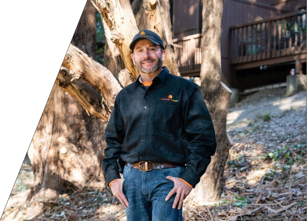 Arbor Vision member standing in front of a tree smiling at the camera