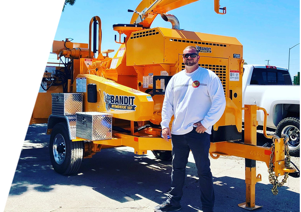 Arbor Vision member standing infront of a tree service truck