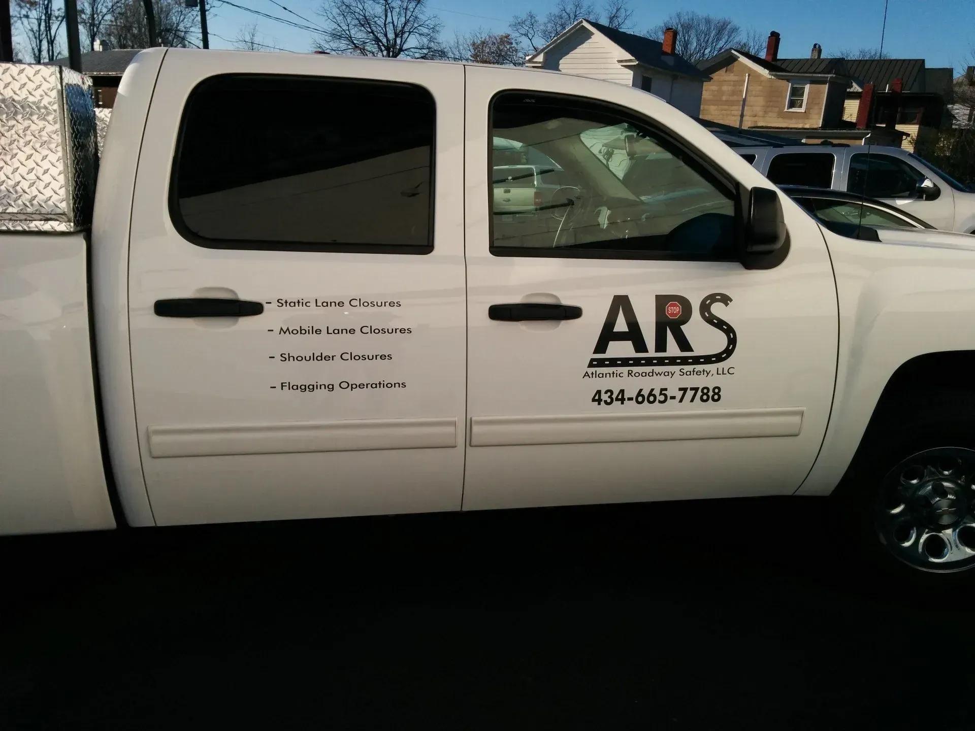 A white truck with ars written on the side.