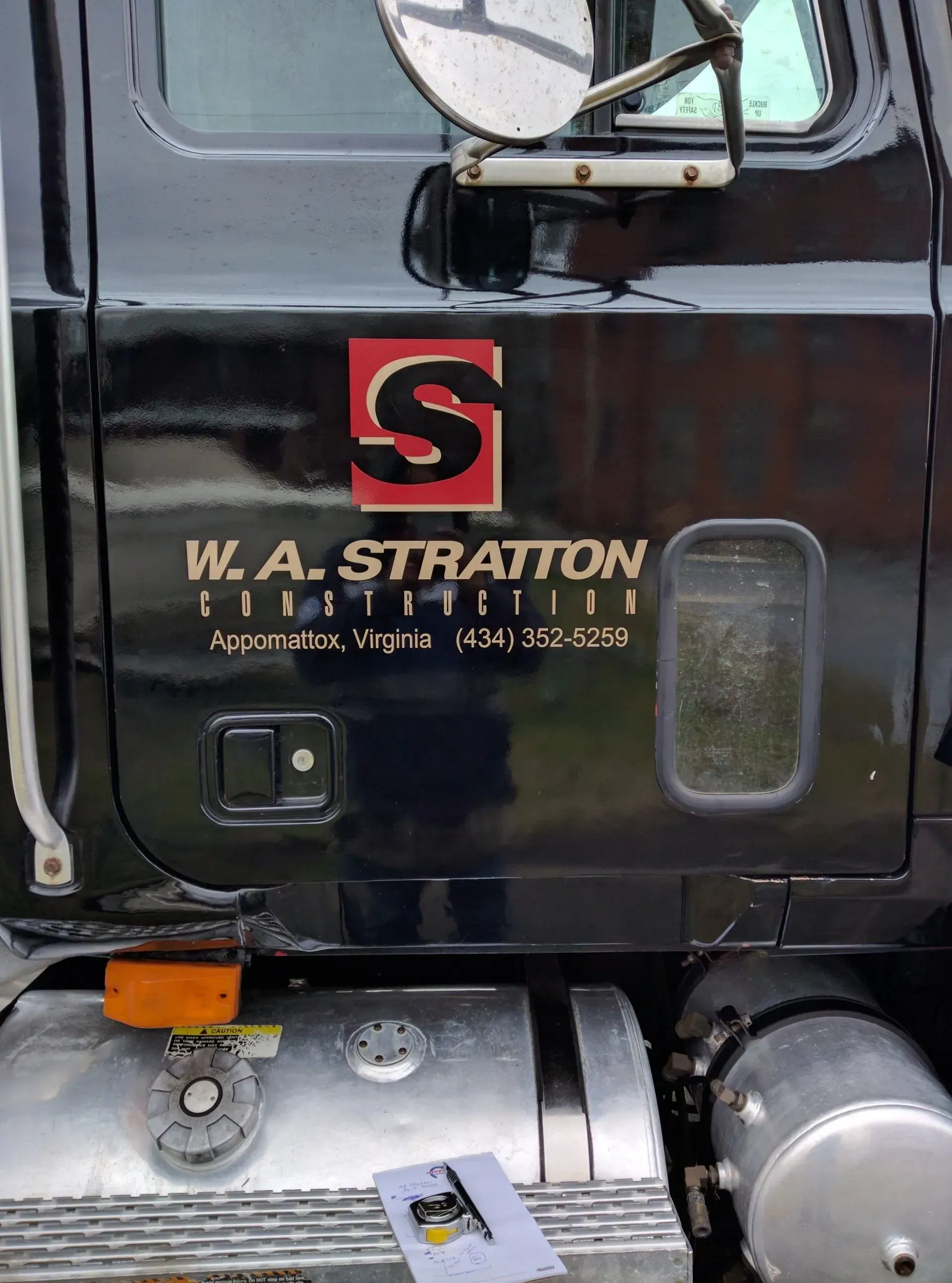 A black truck with the word stratton on the side.