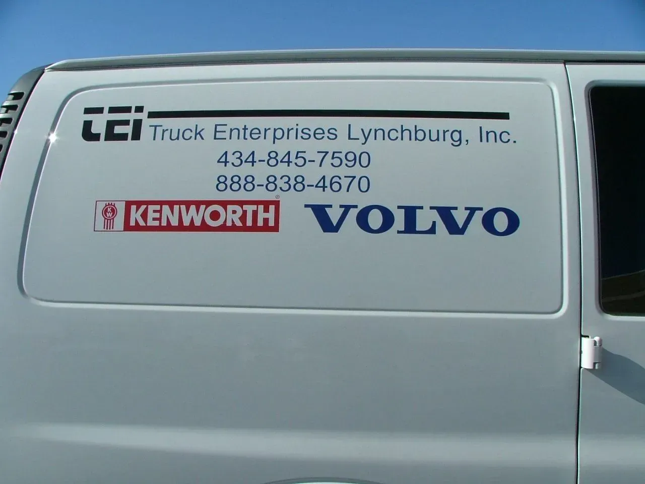 A white van with volvo written on the side.