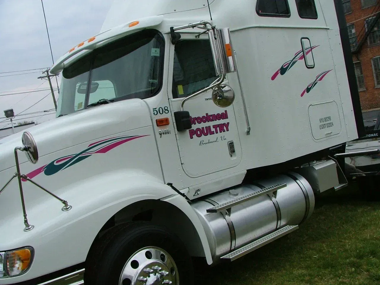 A white semi truck with the word poultry on the side.
