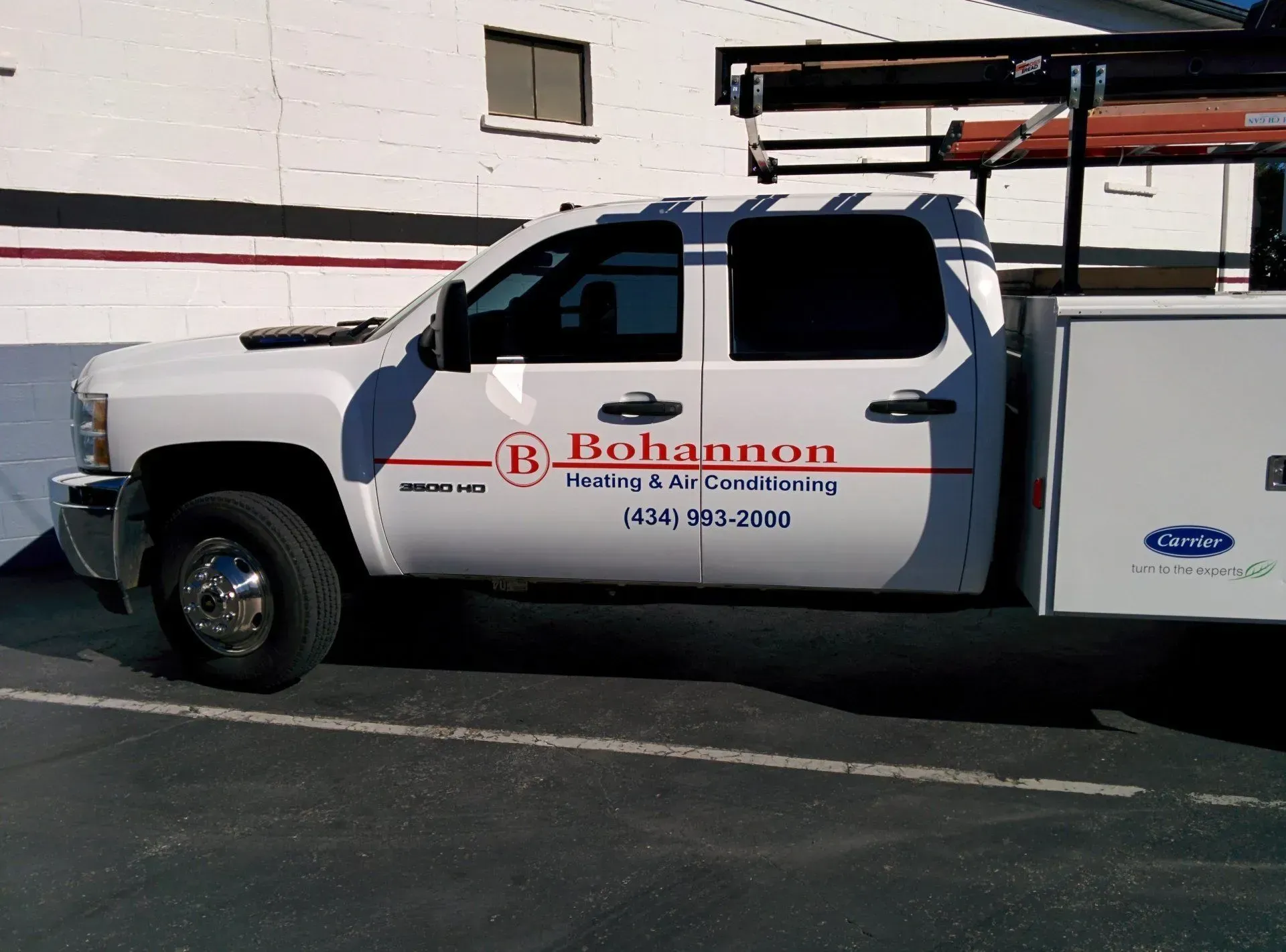 A white bohannon truck is parked in a parking lot.