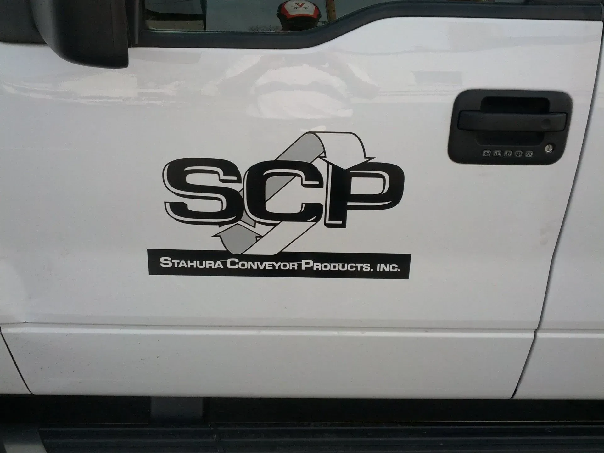 A white truck with the word scp on the side.