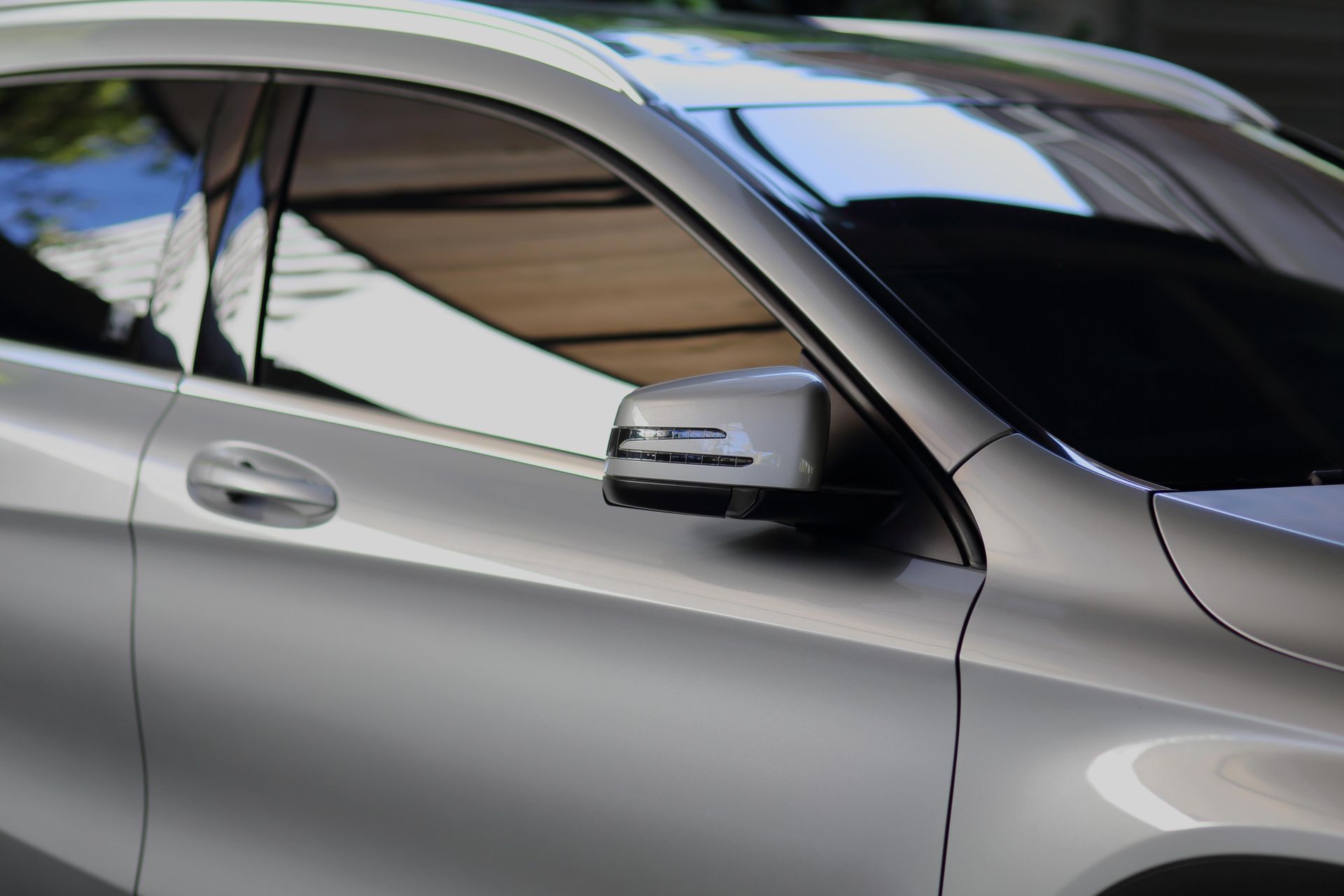 A silver car is parked in a parking lot.