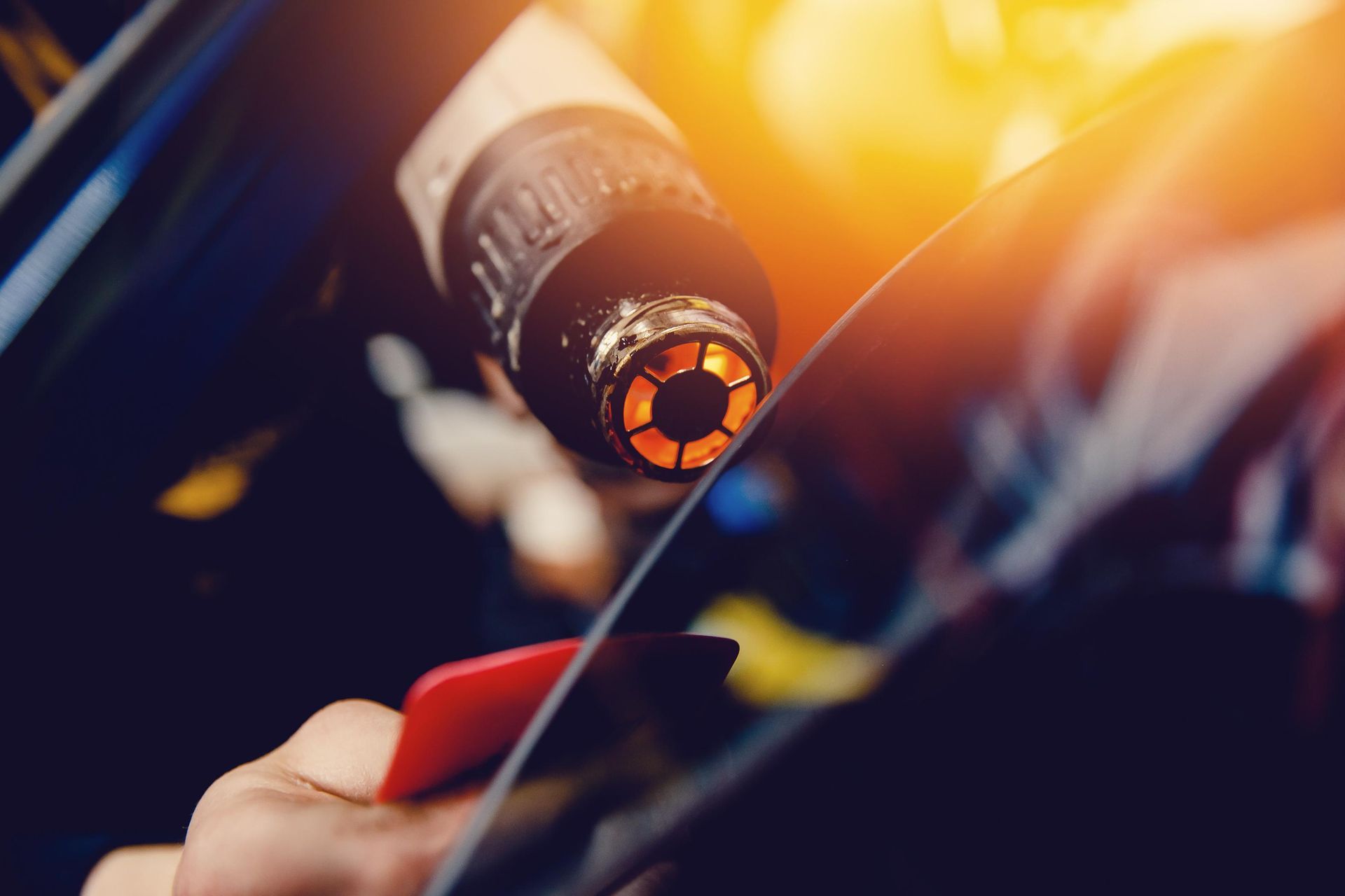Master installs a tint film for the car glass.