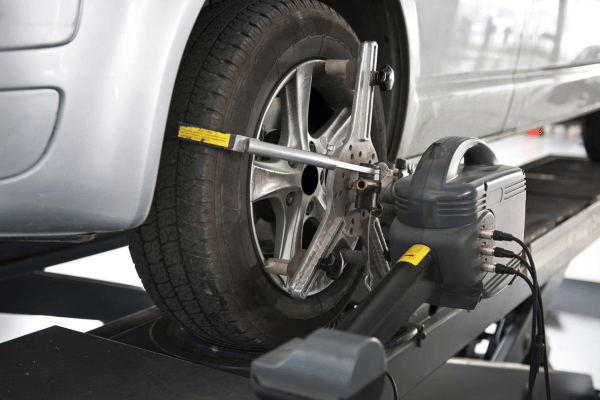 Wheel alignment machine attached to car tire
