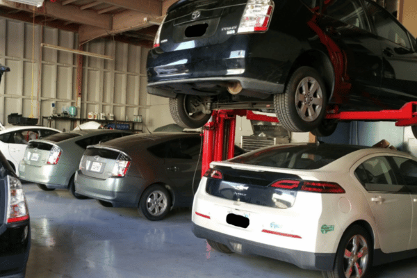 Multiple cars in Electron Automotive repair shop with vehicles on lifts
