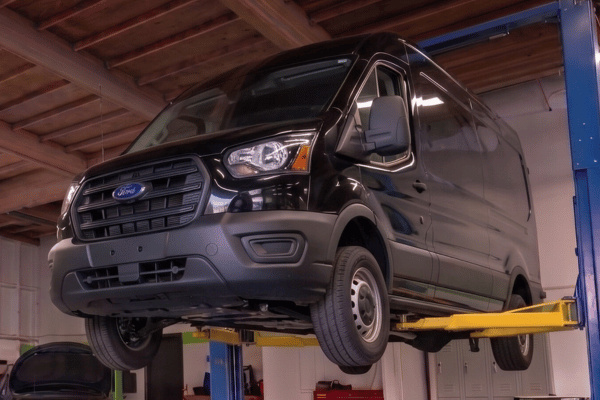 Service van raised on lift in auto shop