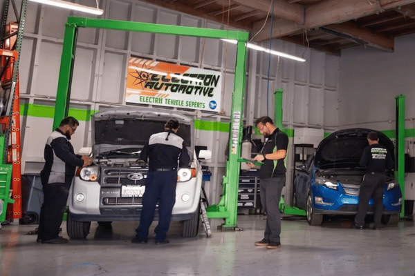 Electron Automotive repair shop with multiple technicians servicing vehicles
