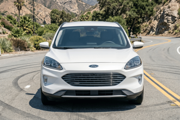 White Ford SUV driving on mountain road
